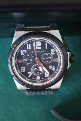 a watch that is sitting on a green table