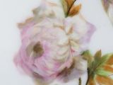 a plate with flowers painted on it on a table