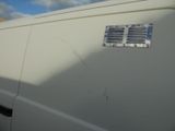 a picture of a white van with a metal grille on the side