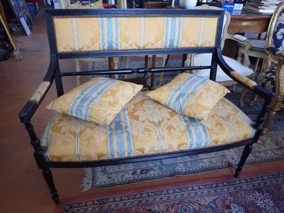 a bench with pillows on top of it in a room