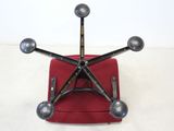 an image of a red chair with four metal balls on top of it