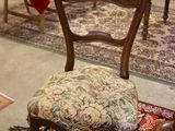 a chair that is sitting on a rug in a room