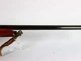 a rifle with a wooden barrel and a wooden handle
