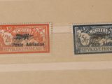trois timbres différents sur un bout de papier accroché au mur