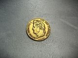 a close up of a gold coin on a white surface