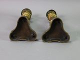 pair of antique brass candlesticks on a white background