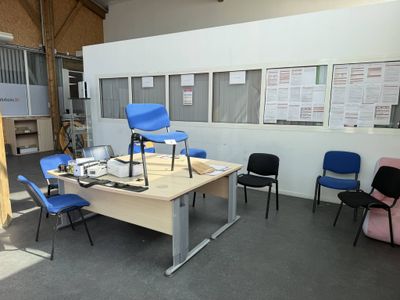 a room with several chairs and a table in it