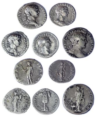 a close up of a bunch of silver coins on a white surface