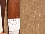 a person holding a pair of skis with a tag on it