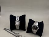 two watches and a watch on display on a table