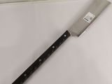 a large knife on a cutting board on a table