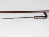 an image of a knife and a cane on a white surface