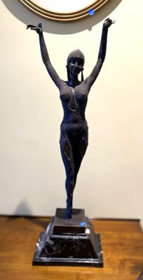 a statue of a woman holding a clock above her head