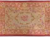 a close up of a rug on a white background with a pink border