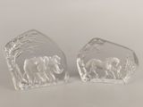 pair of clear glass elephant bookends on a white background
