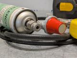 a close up of a gas can and a hose on a table