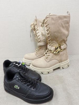 two pairs of black and white shoes with gold chains on them