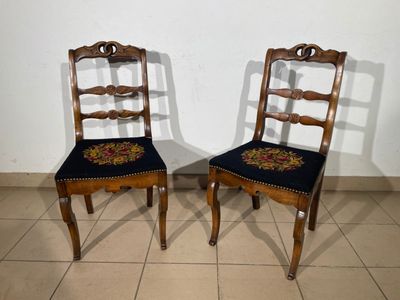 two chairs that are sitting next to each other on a tile floor