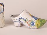 two ceramic shoes that are sitting next to each other
