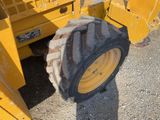 a large tire on the back of a construction vehicle
