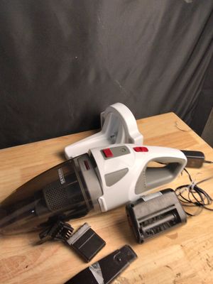 a vacuum that is sitting on a table next to a cell phone