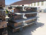 a large pile of steel on the ground in front of a building