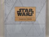 a book with a star wars logo on it sitting on a table