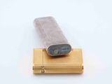 a lighter that is sitting on top of a wooden stand