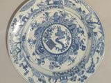 a blue and white plate with a picture of a bird on it