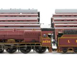 two trains that are sitting next to each other on the tracks