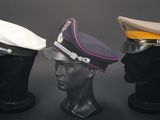 three hats on a mannequin head on a black background