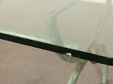a glass table with a metal frame and a glass top