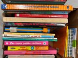 many books stacked on top of each other in a box