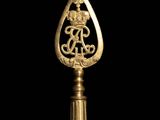 an image of a gold bottle opener with a dragon on it