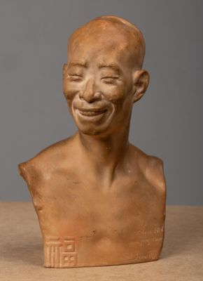 a close up of a clay bust of a man with a smile on his face
