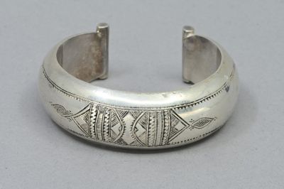 silver cuff bracelet with a fish motif on the side