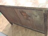 a wooden cabinet with a marble top on a wooden floor