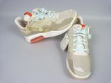 pair of white and orange sneakers with laces on them