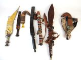 several different types of knives on a white surface