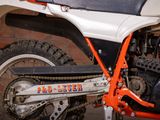 a close up of a dirt bike parked in a garage