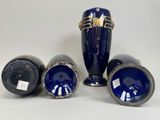 three blue vases sitting next to each other on a white surface