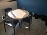 a small table and two chairs in the corner of a room