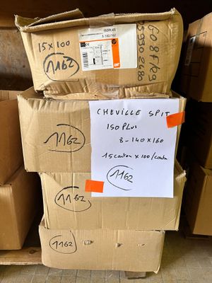 several cardboard boxes stacked on top of each other with a sign attached to them