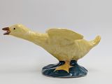 a yellow duck that is sitting on top of a blue base