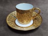 a cup and saucer sitting on a table