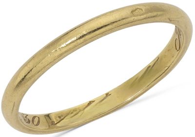 a close up of a gold ring on a white background