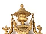 a gold clock with a bird on top of it
