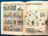 someone is holding a comic book open to a page with a picture of people in the background