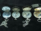 many different types of pocket watches on a black surface