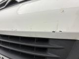 a close up of the front grille of a white van